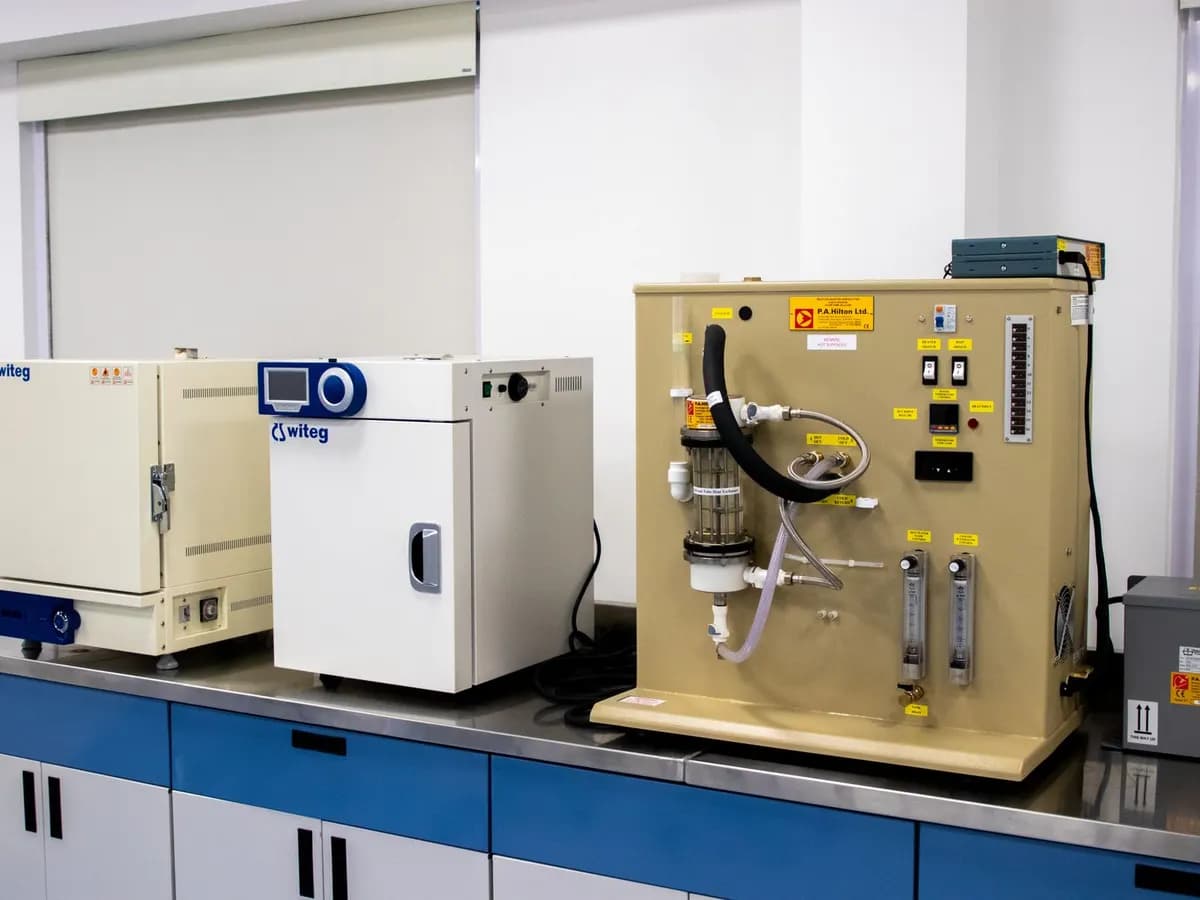 Laboratory bench lined with ovens, incubators and analytical equipment